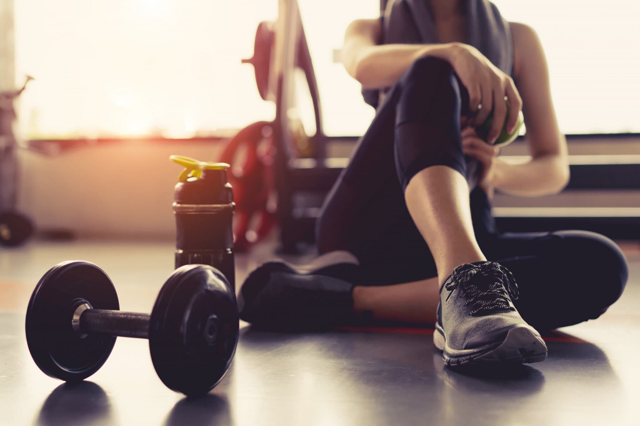 Woman at gym resting after B12 energy injection at Health Pointe Jacksonville