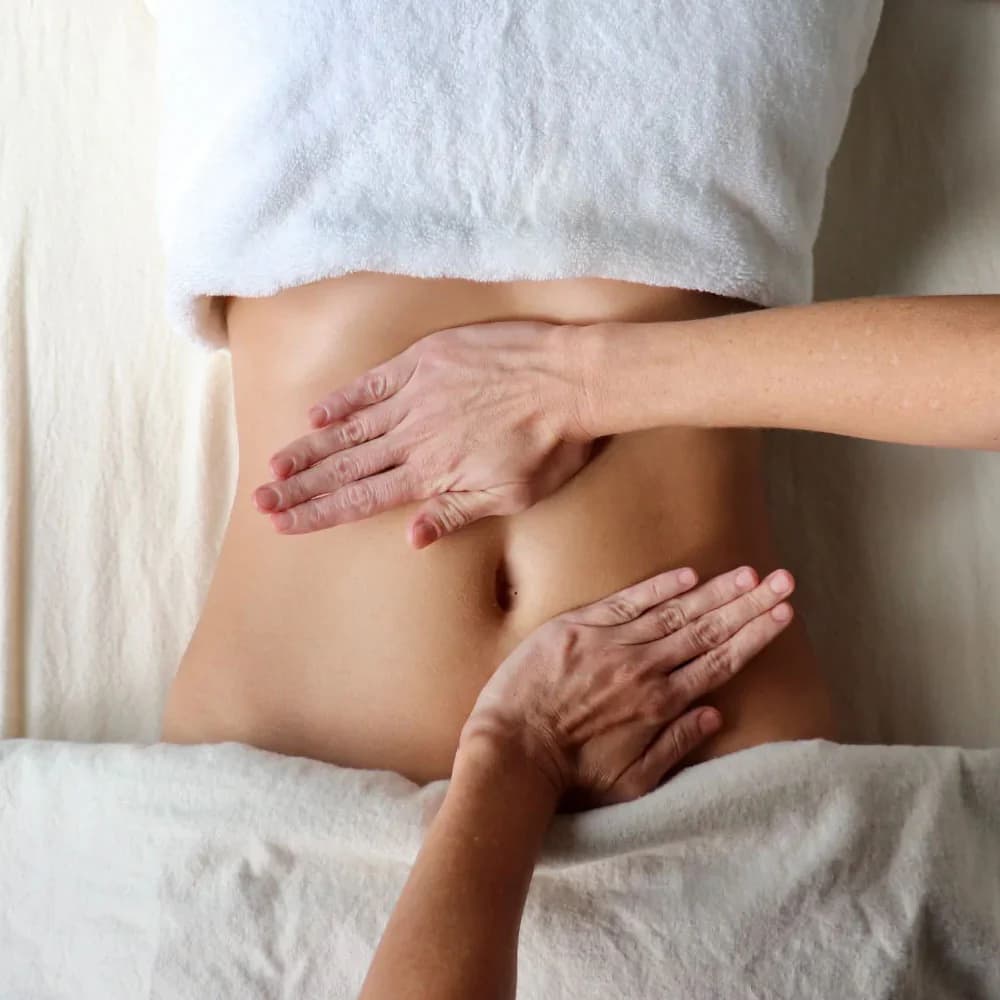Manual lymphatic drainage massage therapist performing abdominal MLD technique at Health Pointe Jacksonville