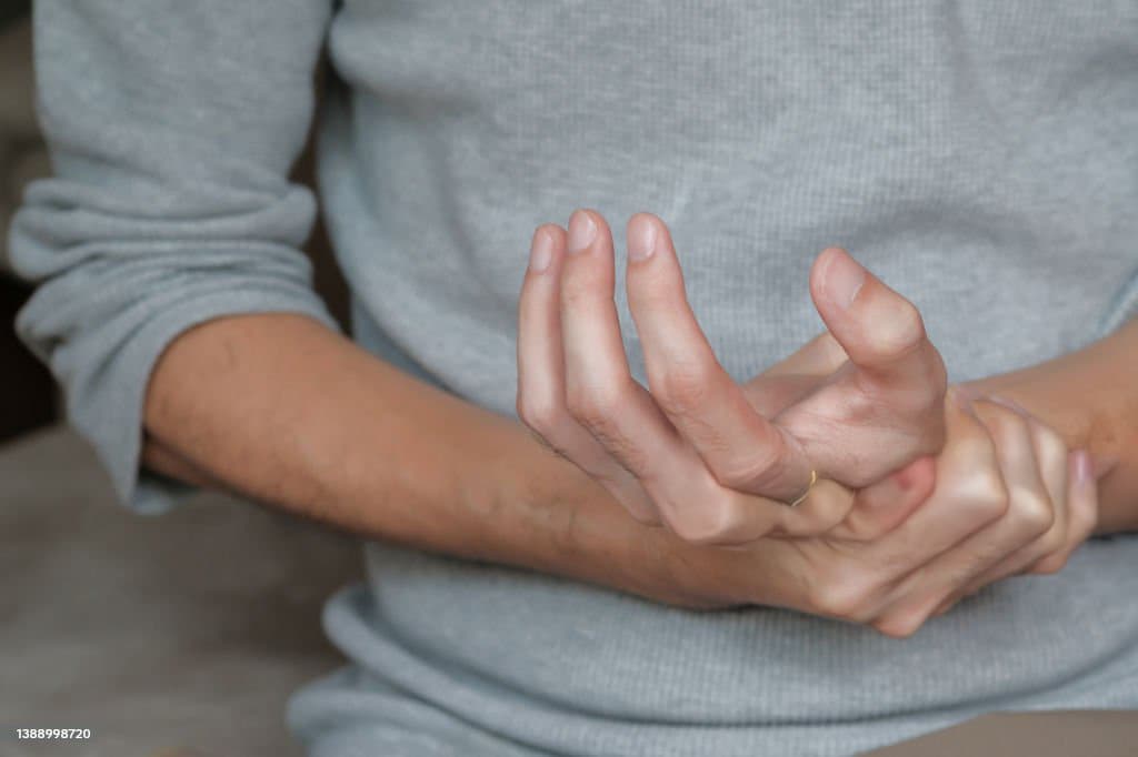 Person experiencing hand and joint pain from neurological disorder seeking acupuncture at Health Pointe Jacksonville