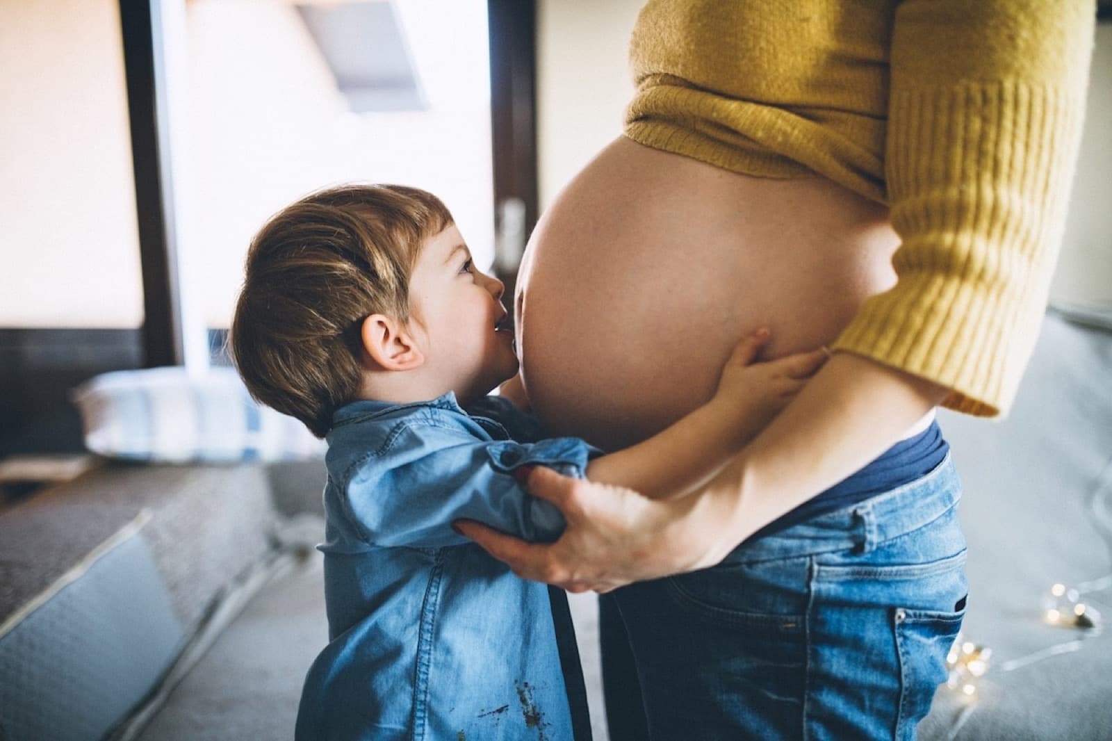 Pregnant mother with toddler kissing belly — fertility support at Health Pointe Jacksonville