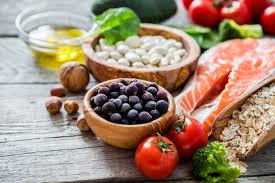 Fertility diet foods including salmon, blueberries, beans, broccoli, tomatoes, oats and walnuts