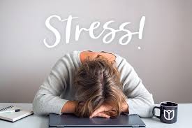 Woman resting her head on a laptop in exhaustion beneath the word Stress